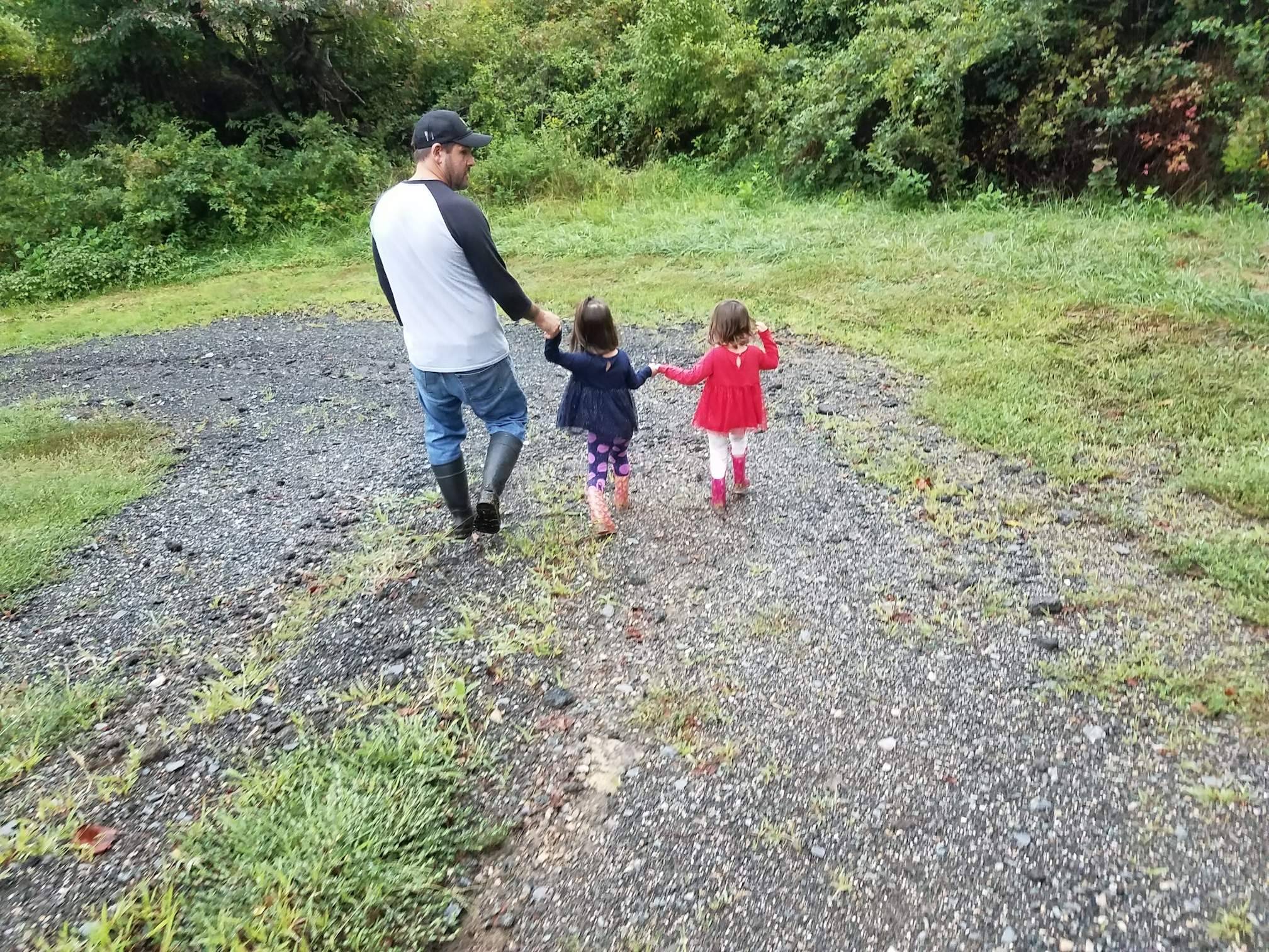 dad and daughters on the farm