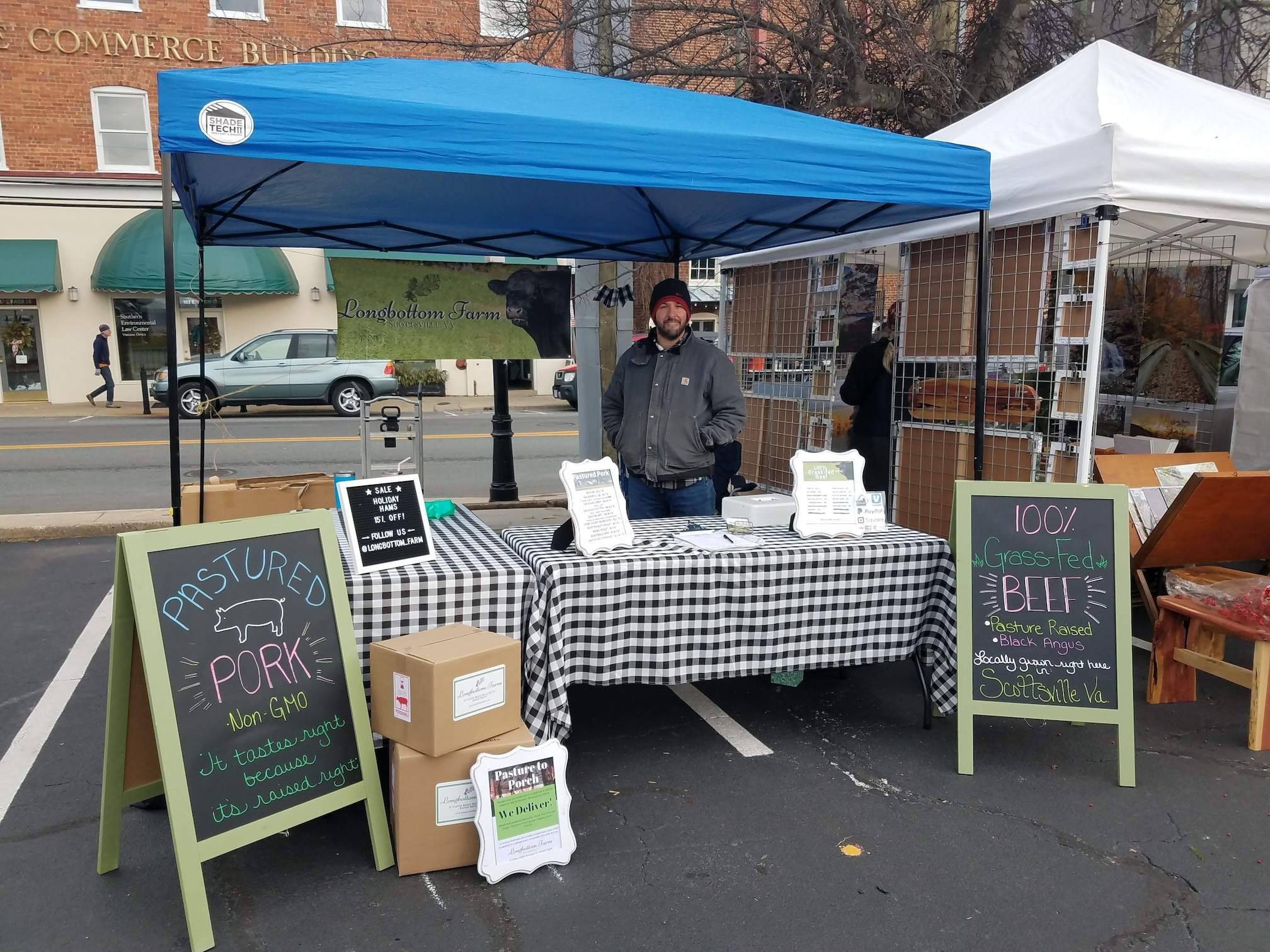 Tending the farmers market booth to promote Longbottom Farm
