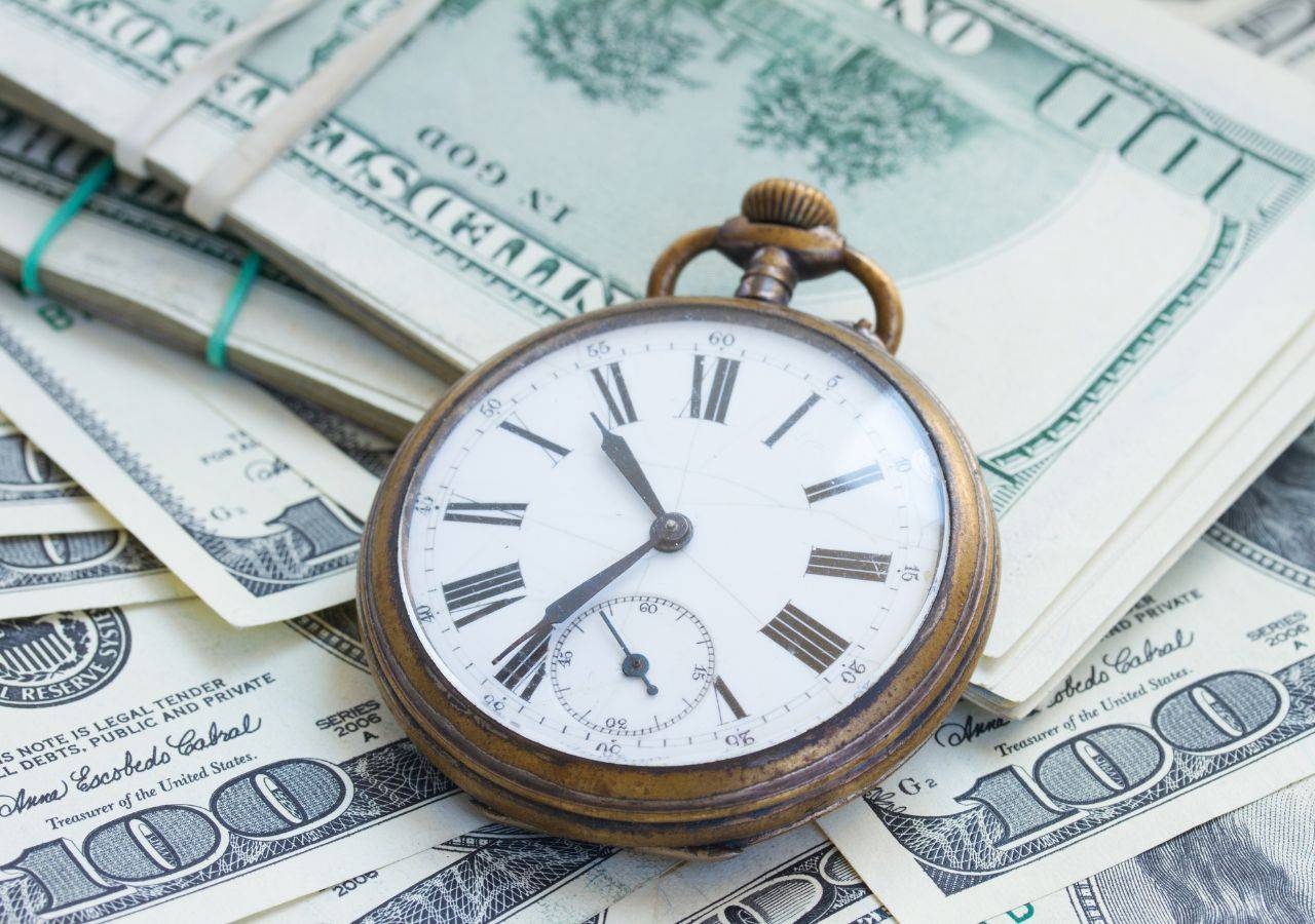 clock and money representing time is money when scaling your small farm