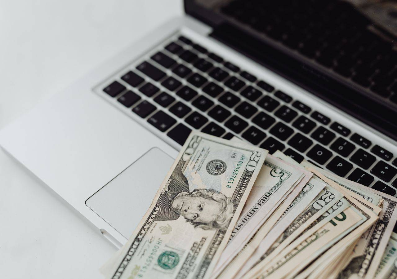 Computer and cash representing online farm sales